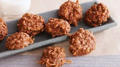 chocolate cookies on a tray next to a glass of milk