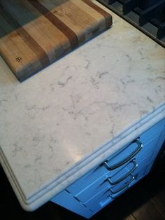 a cutting board sitting on top of a blue drawer