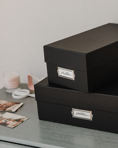 two black boxes sitting on top of a table