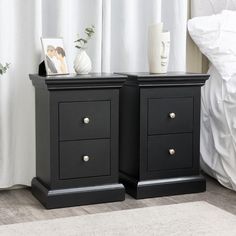 two black nightstands sitting next to each other