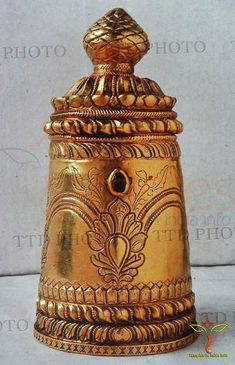 an ornately decorated brass vase with a dome on the top is shown in front of a white background