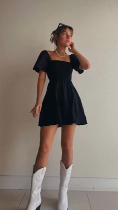 Dress With Cowboy Boots Concert, Concert Cowboy Boots Outfit, Black Dress And White Boots, Slip Dress With Cowgirl Boots, Black Dress For Concert, Colored Cowboy Boots Outfit, Cute Cowgirl Dress Outfits, Cowgirl Outfits Brown Boots, All Black Cowboy Boots Outfit