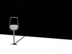 a wine glass sitting on top of a white table next to a black wall and floor