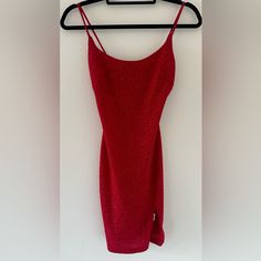 a red dress hanging up on a hanger