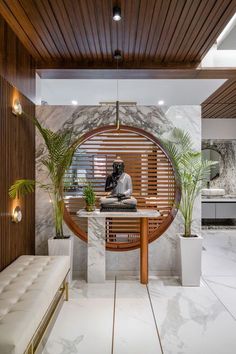 a living room with a couch, table and potted plants