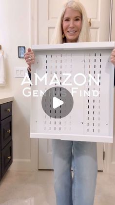 a woman holding up a white sign with the words amazon gems finder on it