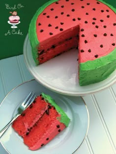 a watermelon cake on a plate with a slice taken out of the cake