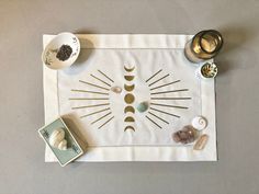 a placemat that has various items on it, such as candles and tea bags