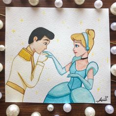 a drawing of prince and princess on paper with pearls around it, surrounded by beads