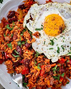 a white plate topped with rice and an egg