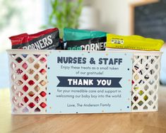 a nurse's and staff thank you sign on a basket filled with candy bars