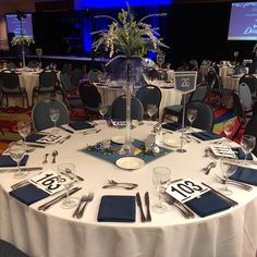 a table set up with place settings, silverware and napkins for an event