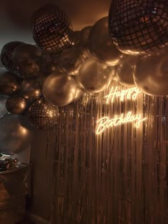 balloons and disco balls are hanging from the ceiling