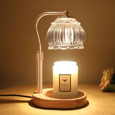 a glass lamp sitting on top of a wooden table