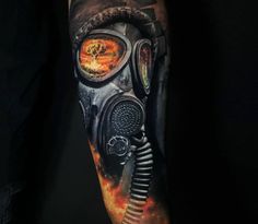 a man's arm with a gas mask and flames in the air on it