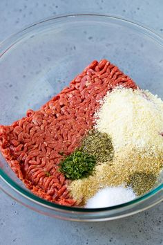 ground beef, spices and seasoning in a glass bowl