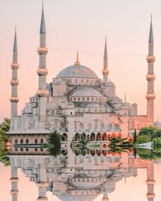 an image of a building that is reflecting in the water