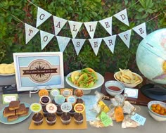 a table topped with lots of food and desserts