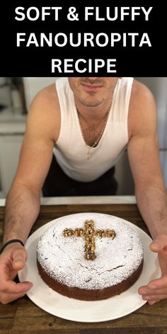 a man sitting at a table in front of a cake with a cross on it