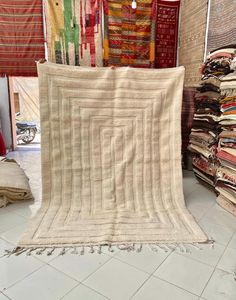 a pile of rugs sitting on top of a white tiled floor