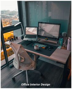 an office desk with two laptops and a desktop computer on it in front of a large window