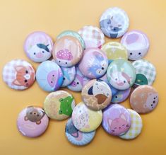 a pile of buttons sitting on top of a yellow table