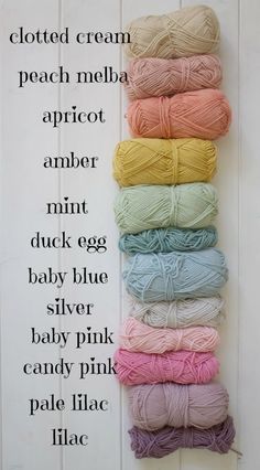 several skeins of yarn are lined up on a white board with text that reads, cotton cream peach melba apricot