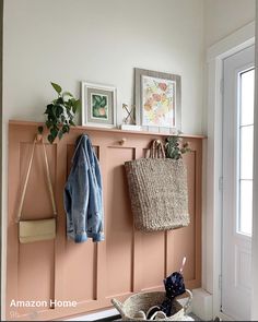 an entryway with baskets and coats hanging on the wall