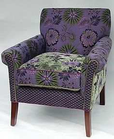 an upholstered chair with purple and green fabric