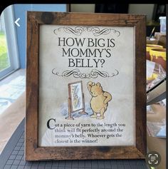 a wooden frame with a sign on it that says how big is mommy's belly?