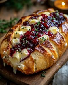 a cranberry and cheese bread on a cutting board