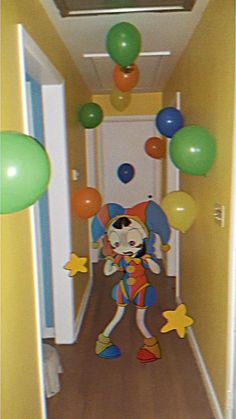 the clown is walking down the hallway with balloons