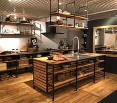 a large kitchen with lots of wooden shelves