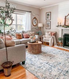 a living room filled with furniture and a tree in the middle of the room on top of a rug