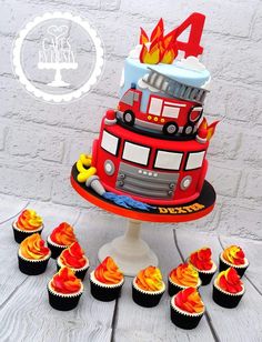 a birthday cake with cupcakes in the shape of a firetruck