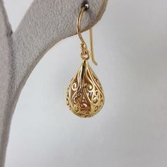 Embrace the allure of our Alluring Gold Teardrop Nightingale Earrings, blending bohemian charm with elegant craftsmanship. These earrings feature a teardrop design adorned with intricate filigree work, inspired by vintage aesthetics. Crafted with gold plating, they measure approximately 11 mm (7/16 inch) in width and 52 mm (2 1/16 inches) in length, with a total weight of 3.2 grams. Perfect as a unique gift or for adding a touch of bohemian flair to any outfit." ✓ Bohemian Charm: Intricate filig Vintage Aesthetics, Bride Jewelry, Faux Pearl Earrings, Gold Bride Jewelry, Bride Jewellery, Pendant Rings, Chain Earrings, Earring Necklace, Gold Plating