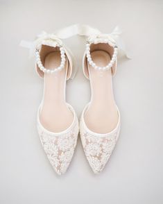 Crochet lace pointy toe flats for comfortable wear throughout your special day and perfect for wedding party. With pearl ankle strap to create a classic yet sophisticated look for any occasion. DETAILS: UPPER: Synthetic upper and lining MATERIALS: Manmade outsole HEEL HEIGHT: 0.3" ORIGIN: Imported Spring Wedding Shoes With Lace And Ankle Strap, Spring Wedding Shoes With Ankle Strap In Lace, Spring Lace Wedding Shoes With Ankle Strap, Chic Low Heel Ballet Flats For Wedding, Spring Bridesmaid Closed Toe Flats, Low Heel Wedding Flats For Spring, Elegant Wedding Pointed Toe Flats With Ankle Strap, Spring Wedding Flats With Low Heel, Spring Wedding Pointed Toe Closed Flats