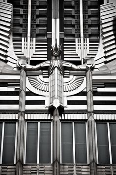 an abstract photograph of a building's architecture with multiple windows and decorative designs on the facade