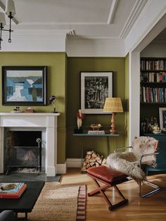 a living room filled with furniture and a fire place next to a bookshelf