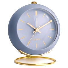 a blue and gold clock sitting on top of a stand