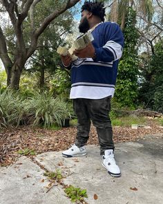 a man standing on top of a cement slab holding a piece of paper in his hand