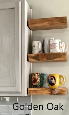 two wooden shelves holding mugs and cups in a kitchen with the words golden oak above them