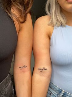 two women with tattoos on their arms and one has a tattoo that says, i love you