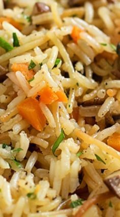 a close up view of rice with carrots and mushrooms