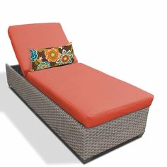 an orange and brown chaise lounger with a pillow on it's back