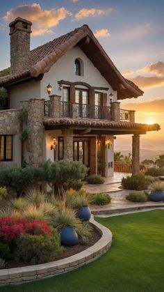 a large house with lots of plants and flowers in front of it at sunset or dawn