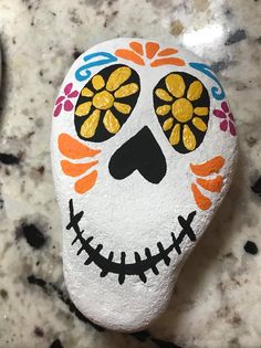 a painted rock sitting on top of a counter