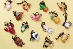 a collection of animal key chains on a yellow background