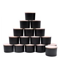 a stack of black pots sitting next to each other on top of a white surface