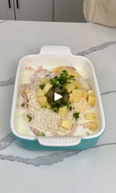 a plastic container filled with food sitting on top of a white tablecloth covered counter